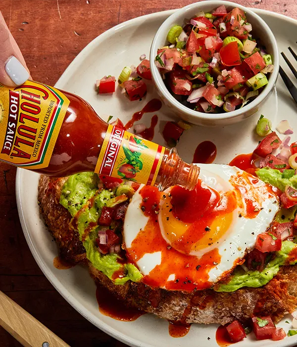 Elevate Your Tabletop with Authentic Mexican avocado toast with fried egg, topped with cholula hot sauce