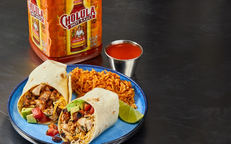 Breakfast Burrito with rice and cholula hot sauce