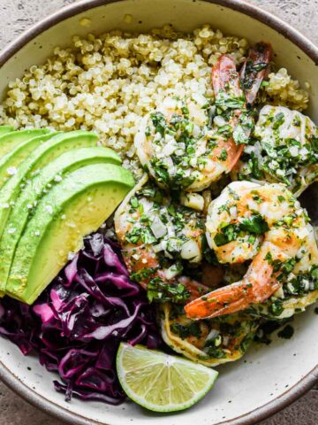 Close up picture of a chimichurri shrimp bowl with all the toppings.