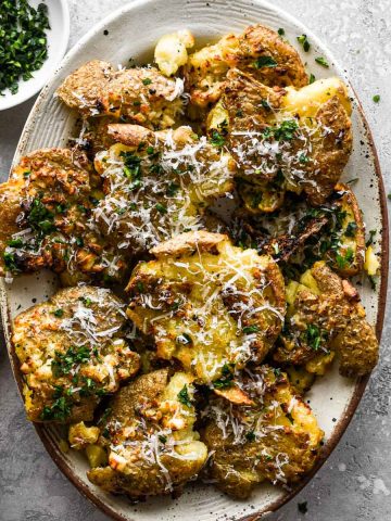 Air Fryer Smashed Potatoes on an oval plate