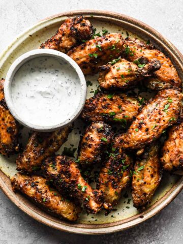 Up close of the wings on a round serving plate.