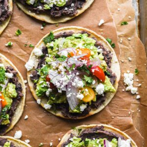 Up close of finished tostada with cheese and cilantro.