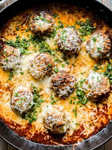 Chicken parmesan meatballs in a skillet freshly baked.