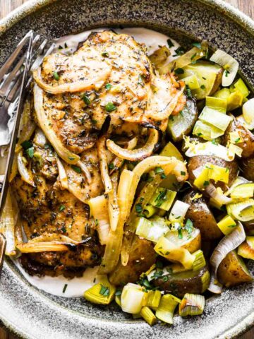 Finished chicken and leeks in a bowl.