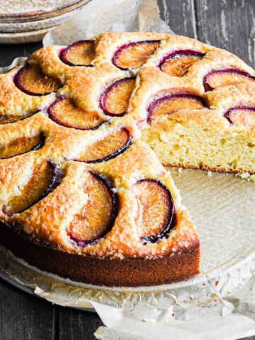Plum cake with a slice taken out.