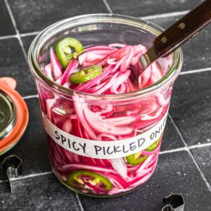 Spicy pickled red onions in a jar.