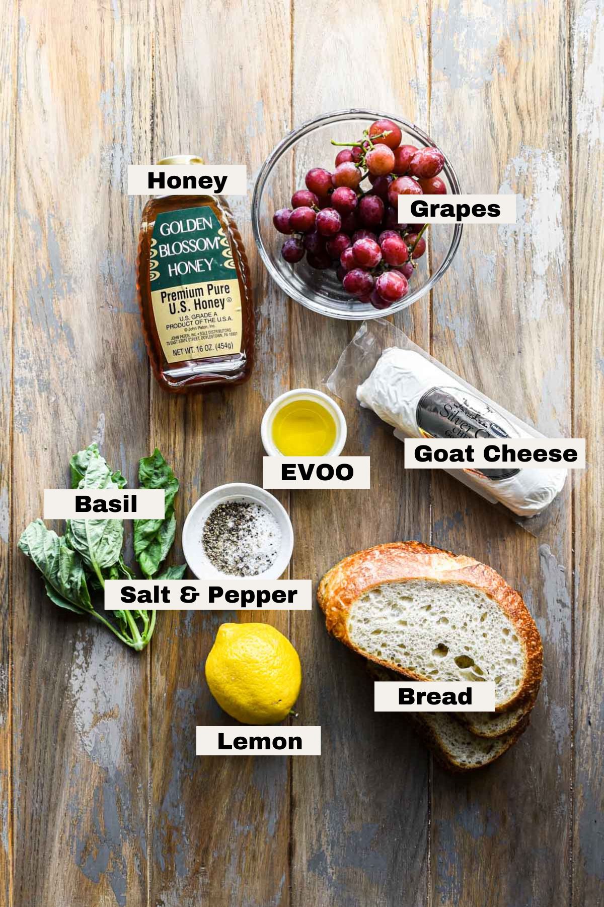 Ingredients on a table for whipped goat cheese with roasted grapes.