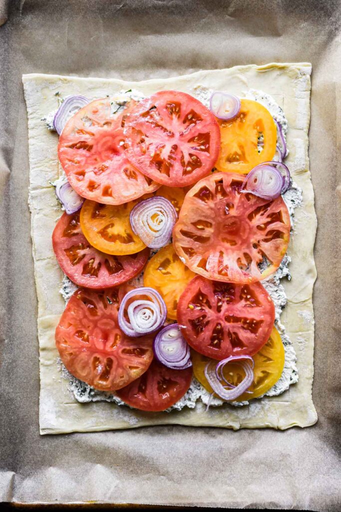 Laying the tomatoes and shallots.