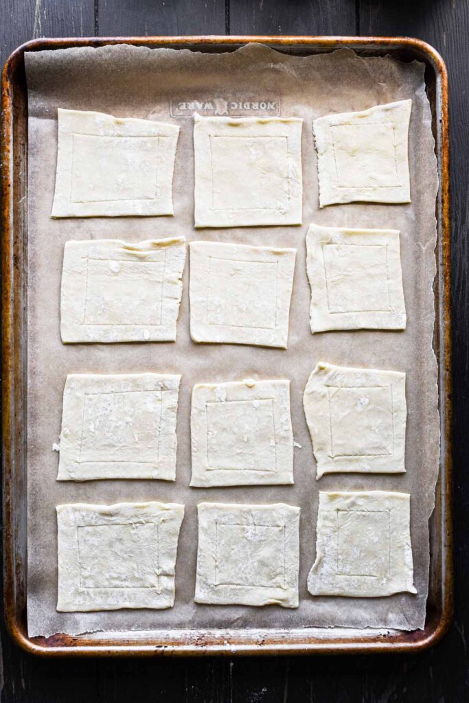 Scoring the edges of the puff pastry.