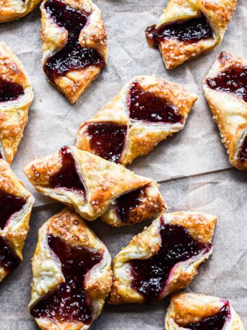 Close up image of puff pastry jam tartlets on a serving board.