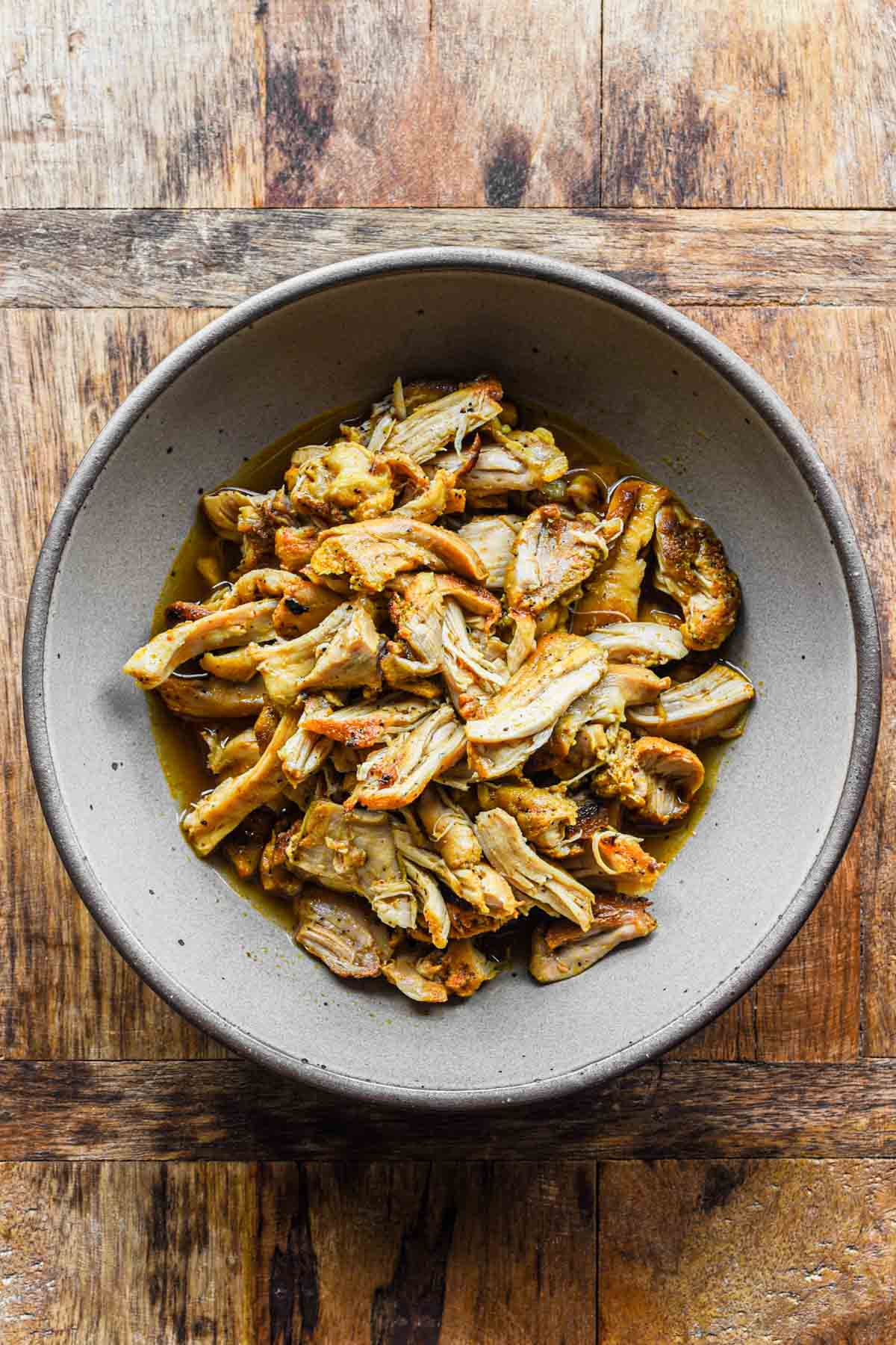 shredded chicken thighs in a bowl.