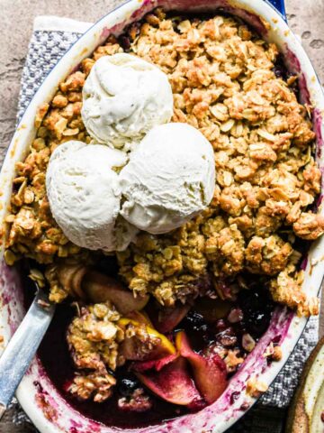 Freshly baked apple blueberry crumble with ice cream.
