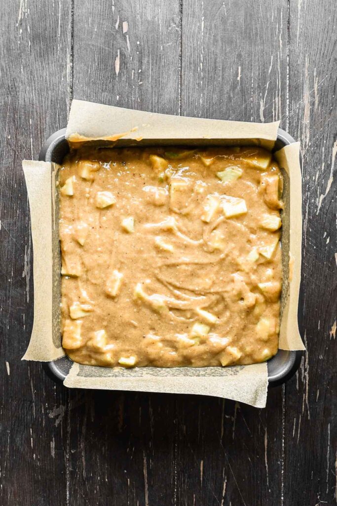 Adding batter to prepared baking pan.