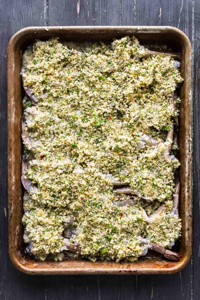 Breadcrumbs on top of shrimp prior to baking.