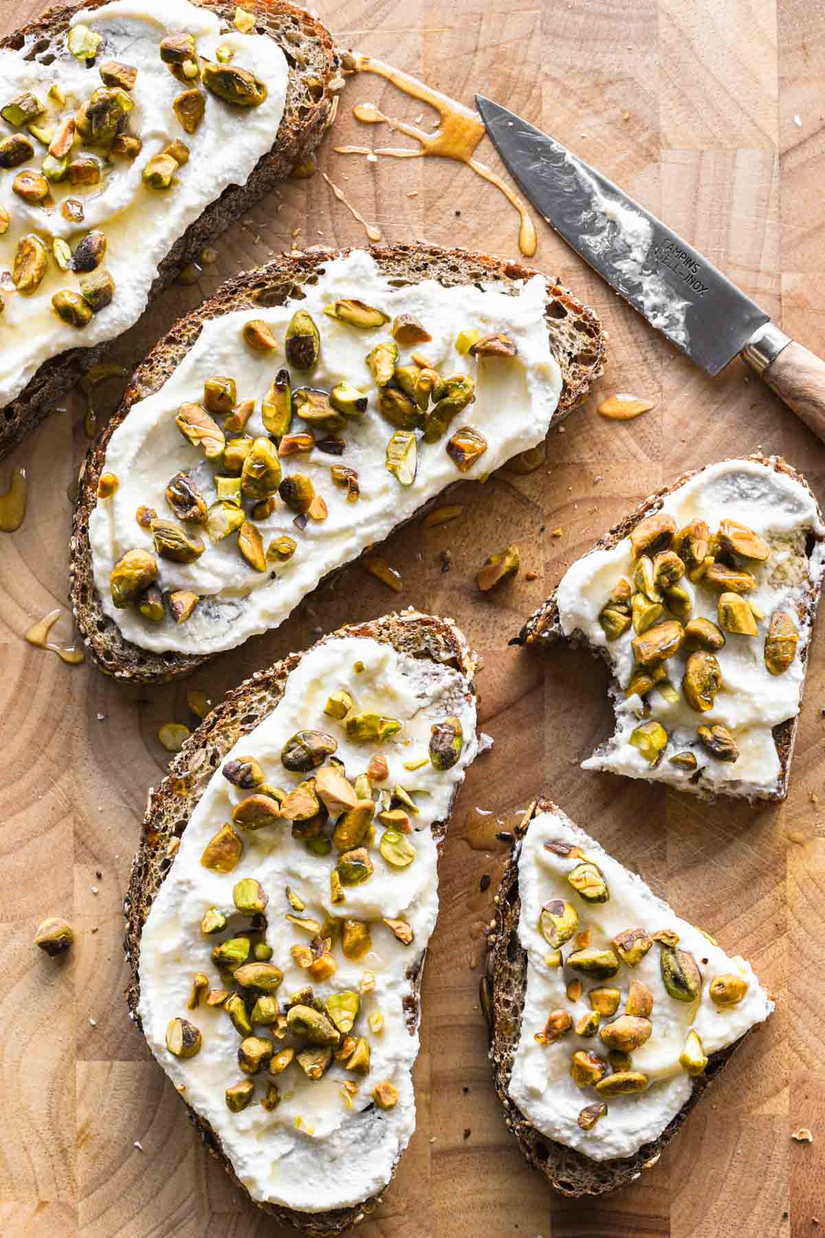 Ricotta toasts on a cutting board.