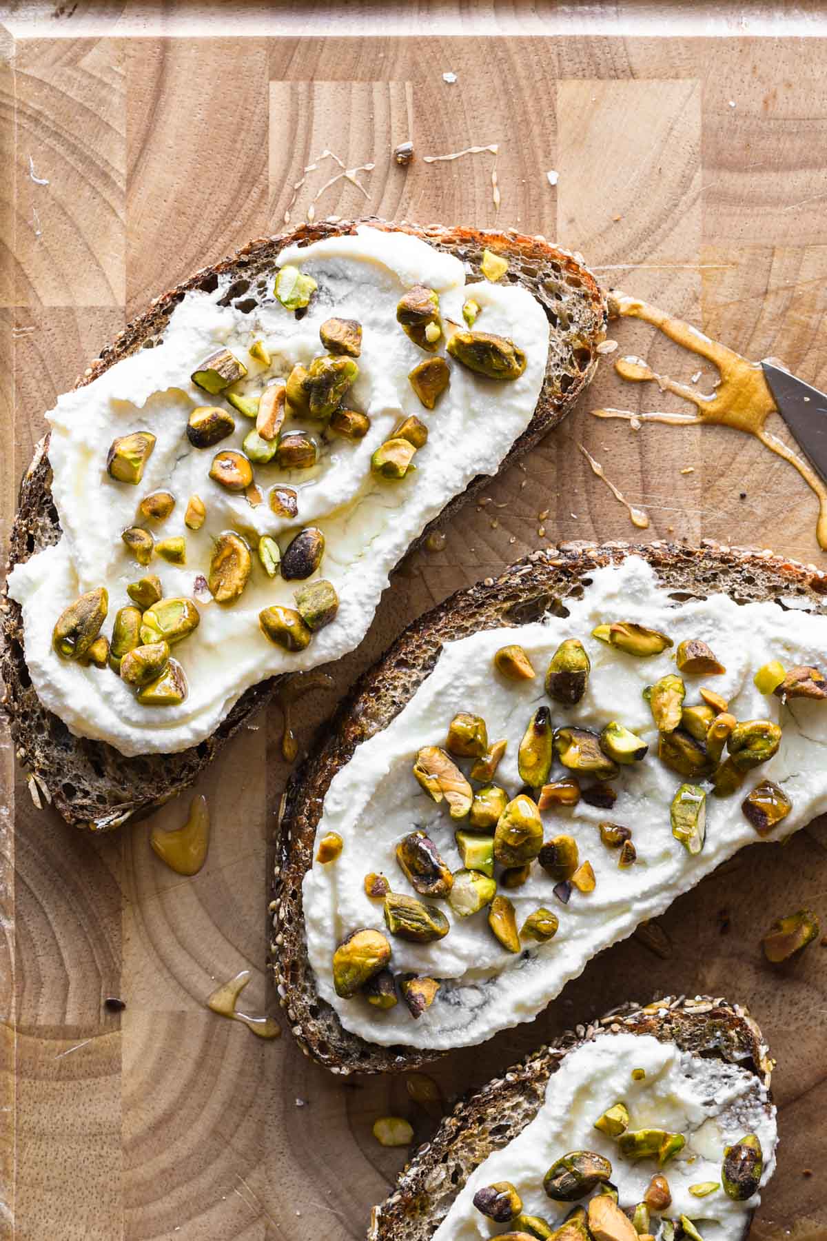 Ricotta toasts on a board for serving.