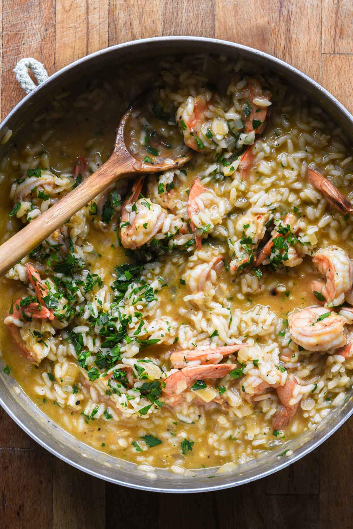 Finished shrimp scampi risotto with fresh parsley on top.