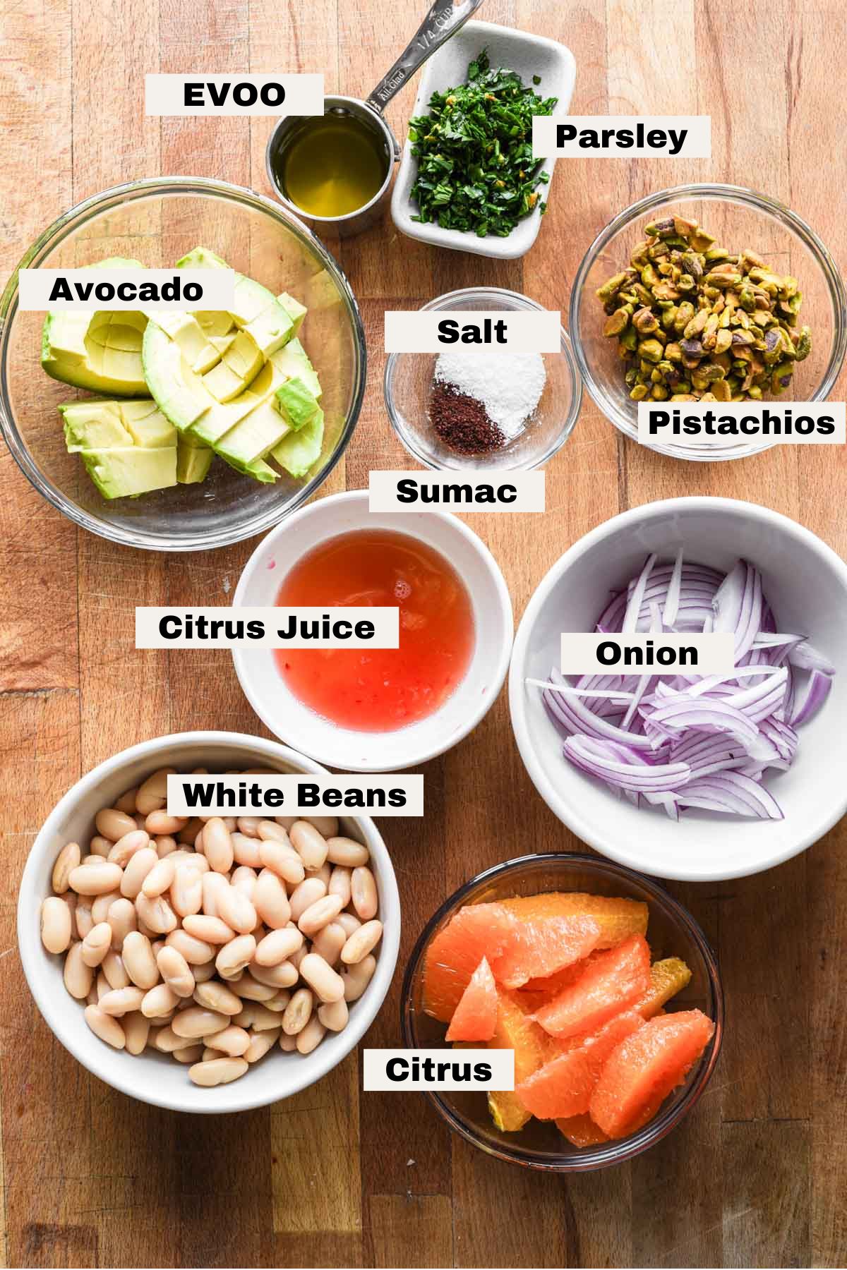Ingredients on a table for white bean citrus salad.