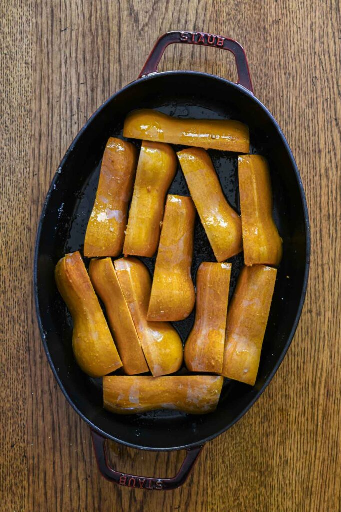 Seasoned squash in a pan before baking.