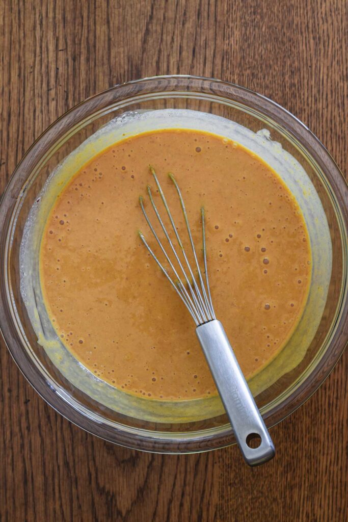 Adding the pumpkin to the wet ingredients.